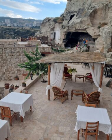 an outdoor dining area with tables and chairs