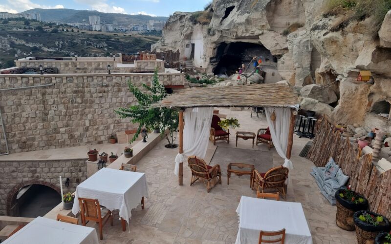 an outdoor dining area with tables and chairs