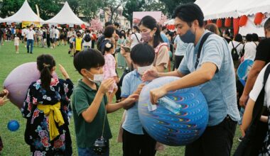 a group of people playing with a blue ball