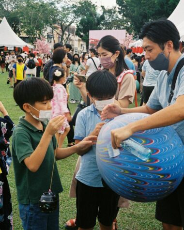 a group of people playing with a blue ball
