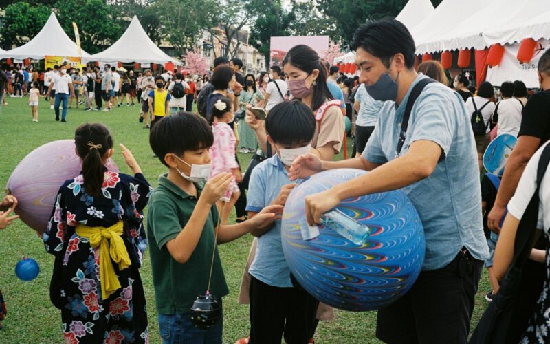 a group of people playing with a blue ball