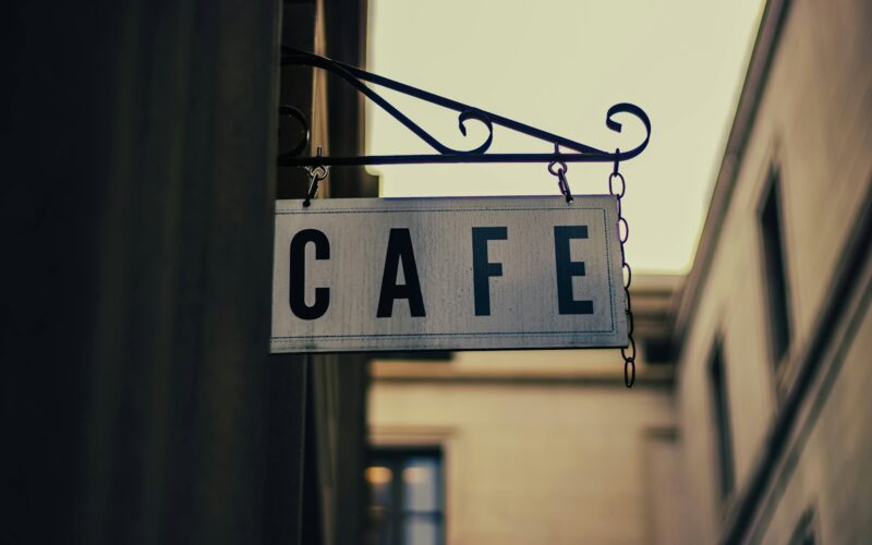 a close up of a street sign hanging from a pole