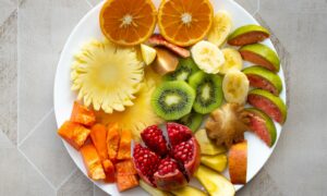 a white plate topped with cut up fruit