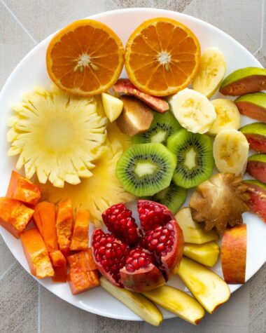 a white plate topped with cut up fruit