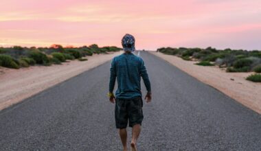 man walking on gray concrete road