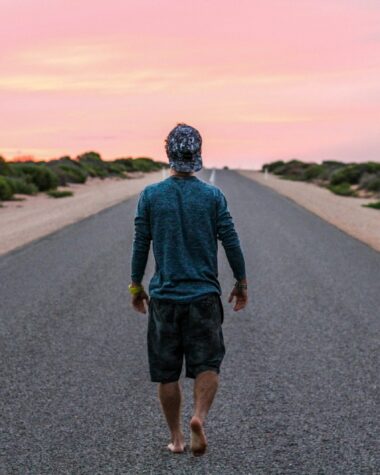 man walking on gray concrete road